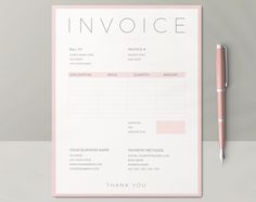 a pink invoice sitting on top of a white table next to a pen