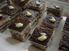 several desserts are arranged on a white platter