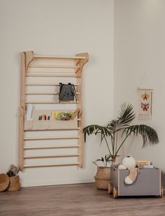 a living room with white walls and wooden shelves on the wall next to a plant