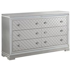 an image of a silver dresser with diamond design on the front and drawers in white