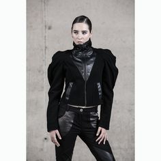 Introducing our Battle Angel Jacket, a striking embodiment of avant-garde fashion and street high fashion. Crafted for the fashion-forward, this winter jacket boasts a unique blend of quality wool felt and faux leather, ensuring warmth and style are perfectly balanced. Designed with practicality in mind, this jacket features pockets and a lining for added comfort. The high collar adds an edgy touch, while the standout feature is the puffed sleeves, setting it apart in the realm of black clothing Futuristic Black Outerwear For Streetwear, Black Punk Biker Jacket For Cosplay, Fitted Black Punk Biker Jacket, Black Biker Jacket For Alternative Fashion In Winter, Black Edgy Biker Jacket For Alternative Fashion, Fitted Techwear Outerwear For Streetwear, Futuristic Black Long Sleeve Outerwear, Gothic Biker Jacket For Winter Alternative Fashion, Gothic Biker Jacket For Alternative Fashion In Winter