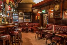 the interior of a bar with brown leather seats