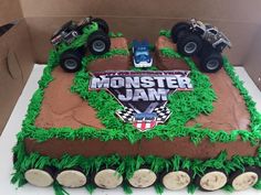 a monster jam themed cake is displayed in a box