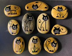 rocks with cats painted on them are arranged in a circle and placed next to each other