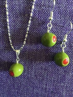 (12,062) Pimento Stuffed Olive Necklace or Earrings  Made from polymer clay, about 1/2" x 3/8" Earrings on silver plate ear wires  Necklace on varied 18" silver plate chain  Olives have pimento on each end. Look pretty real! Nickel-free Polymer Clay Dangle Jewelry, Polymer Clay Round Beads For Jewelry Making, Nickel-free Polymer Clay Necklace Gift, Hypoallergenic Dangle Polymer Clay Jewelry, Small Polymer Clay Jewelry As Gift, Hypoallergenic Polymer Clay Jewelry Gift, Nickel-free Silver Polymer Clay Jewelry, Olive Necklace, Olive Earrings