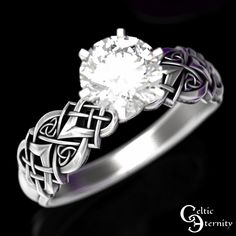 a white diamond ring with celtic designs on it