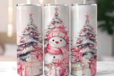 three christmas candles with snowmen and presents on the top one is decorated in pink