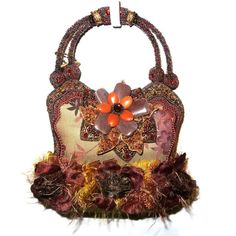 You have found the missing pieces to your designer handbag collection! Here is a beaded handbag or purse from Mary Frances. The body is a brown floral fabric with brown, red and tan flowers, beads and feathers. It measures 7" x 6" x 3 1/2" deep with beaded handle. It has a snap closure. Mint condition it looks like it has never been used. From the estate of a millionaire socialite in downtown Miami. Please see our Not Just China Store for more of this collection. We try to ship within 24 hours o Brown Handheld Evening Bag As Gift, Handmade Brown Handheld Evening Bag, Brown Handheld Handmade Evening Bag, Brown Beaded Pouch Bag, Traditional Brown Formal Bag, Brown Beaded Pouch Shoulder Bag, Brown Pouch Evening Bag As Gift, Brown Beaded Handheld Bag, Handheld Brown Beaded Bag