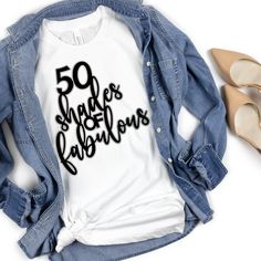 a t - shirt with the words 50 shades of fabulous printed on it next to high heel shoes