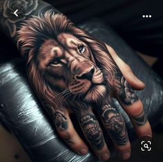 a man's hand with a lion and roses tattoo on the left hand, next to his right hand