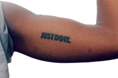 a man's arm with the word just do it written on it in black ink