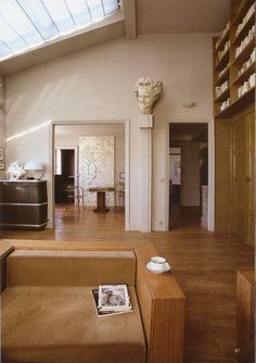 a living room filled with furniture and bookshelves