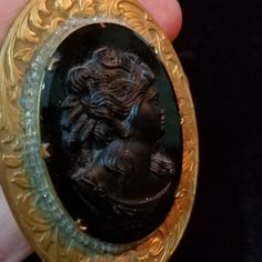 "*Thank you for visiting my shop. Please read the FULL description by clicking on \"Learn more about this item\". All items are Final Sale, no returns.* This is a gorgeous black glass cameo set in a very ornate brass finish metal frame. I date this to somewhere around 1940's or 1950's. The cameo is very 3-dimensional. This is quite a statement piece! It comes on a gold tone 24 inch chain with a clasp. The cameo alone is 36 x 47 mm. The entire piece measures 2 x 2 5/8 inches. The cameo is in exce Crystal Ball Ring, Cute Business Cards, Goth Witch, Cameo Pendant Necklace, Witch Jewelry, Makeup Mirror With Lights, Cameo Necklace, Cameo Pendant, Crystal Necklace Pendant