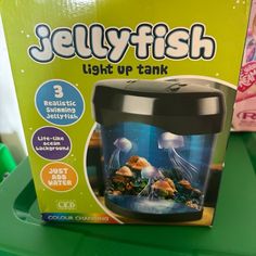 the box for jellyfish light up tank is on display in a store's front window