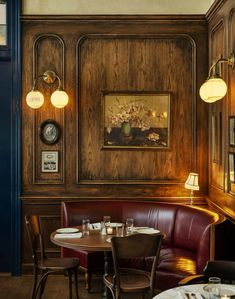 a restaurant with wood paneling and leather booths