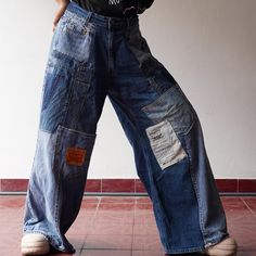 These one-of-a-kind jeans are meticulously handcrafted from upcycled denim sourced from leading brands. Every pair is thoughtfully created by carefully sewing and patching together various fabric pieces, resulting in a unique patchwork design that ensures no two pairs are alike. This craftsmanship reflects a deep attention to detail and a dedication to quality, embodying the skill and passion of the artisans who bring these jeans to life. Inspired by the standout style of the 90s, these jeans of Patched Jeans Outfit Street Style, Utility Wide Leg Recycled Denim Jeans, Utility Wide-leg Recycled Denim Jeans, High Rise Recycled Denim Cargo Jeans In Relaxed Fit, Medium Wash Wide-leg Recycled Denim Cargo Jeans, Medium Wash Wide Leg Recycled Denim Cargo Jeans, Retro Wide-leg Denim Cargo Jeans, Vintage Blue Wide Leg Cargo Jeans, Wide Leg Medium Wash Recycled Denim Cargo Jeans