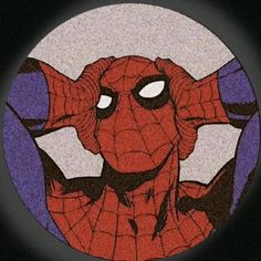 a spider - man with his hands on his ears