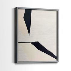 a white and black painting hanging on the wall