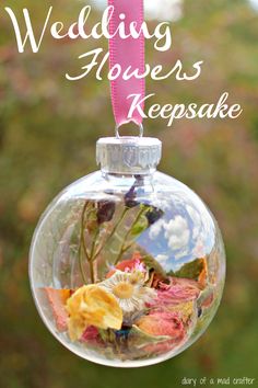 a clear glass ornament with flowers in it