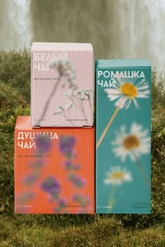 three books sitting on top of each other in front of a tree and water fall