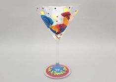 a glass with a rooster painted on it's side and the words happy birthday