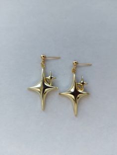 The earrings are adorned with a small star-shaped pendant. The earrings are fastened with stainless steel studs. Earring length - 4.0 cm (1.6 inches) The earrings are packed in a gift box. RECOMMENDATIONS FOR CARE: Do not wet, do not drop, and store in a dark box! - Remove jewelry before exercising, swimming, showering and sleeping. - Avoid contact with moisture such as make-up, moisturizer, lotion, perfume and hairspray. - Store your jewelry in a box or pouch after use. Elegant Gold Plated Star Earrings, Gold Plated Star-shaped Pierced Earrings, Gothic Star-shaped Metal Earrings, Gold Star-shaped Tarnish Resistant Earrings, Gold Plated Star-shaped Earrings For Gift, Gothic Earrings, North Star, Star Earrings, Grunge Fashion