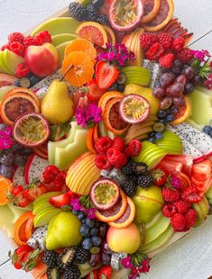 a platter filled with lots of different types of fruit