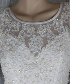 the back of a wedding dress with beading on it