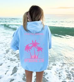 Subscribe and save! Grab your exclusive discount when you join our mailing list! Copy and paste this link into your browser: https://bit.ly/chaseandsunsetsco Embrace the endless pursuit of beauty and tranquility with our 'Forever Chasing Sunsets' Monochromatic Hoodie. This cozy summer sweatshirt features a serene back print of palm trees silhouetted against a setting sun, capturing the timeless allure of sunsets and tropical vibes. PRODUCT INFORMATION: - 50/50 cotton/polyester blend - Medium wei Pink Cotton Sweatshirt For The Beach, Hooded Cotton Top For Vacation, Cotton Hooded Top For Vacation, Blue Hooded Beach Tops, Blue Hooded Tops For The Beach, Blue Hooded Top For Beach, Blue Hooded Tops For Beach, Pink Sweatshirt For Summer Vacation, Pink Summer Vacation Sweatshirt