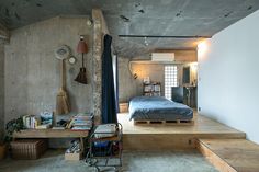 a bed sitting in the middle of a bedroom next to a wooden table and chair