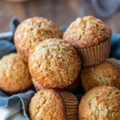 a pile of muffins sitting on top of a blue cloth