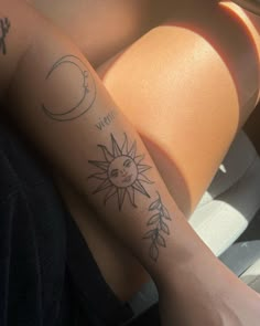 two people with tattoos on their arms and one has a sun and moon tattooed on the arm