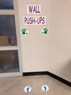 a door with stickers on it that say wall push - ups and hand prints