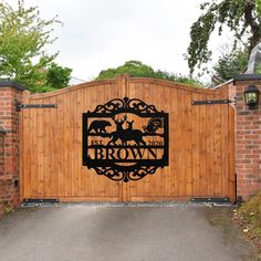 a wooden gate with an iron sign that says brown on the front and side of it