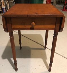 an old wooden table sitting on top of a white floor