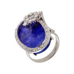 a ring with a blue stone and diamonds on it's shants, set in white gold