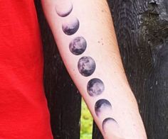 a man with a tattoo on his arm that has phases of the moon