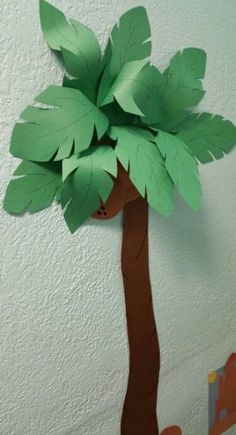 a paper cut out of a tree with leaves on it's head and bottom part