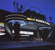 the famous movie theater is lit up at night