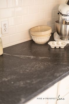 the kitchen counter is clean and ready to be used as a blender, mixer, and bowl