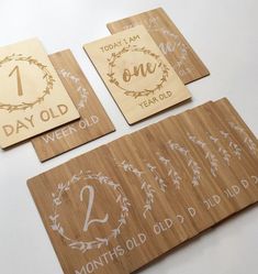 four wooden coasters with numbers on them and one for each child's first birthday