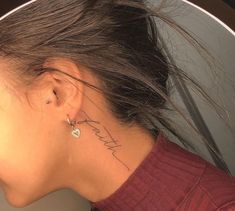 a woman with a small tattoo on her neck