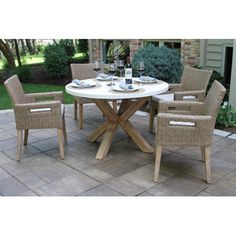 an outdoor table and chairs set up on a patio