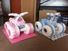 two cakes made to look like baby's carriages are sitting on the floor