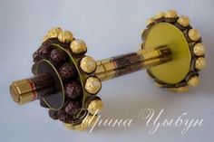 a close up of an object made out of gold and chocolates on a white background