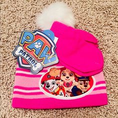 a dog laying on the floor next to its owner's hat and paw patrol stickers