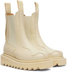 Ankle-high paneled buffed leather Chelsea boots in beige. · Grosgrain pull-loops at collar · Elasticized gusset at sides · Graphic hardware at heel counter · Treaded foam rubber sole · Silver-tone hardware · Platform: H1 in · Heel: H1.75 in Available exclusively at SSENSE. Supplier color: Off-White Beige Calf Leather Boots With Reinforced Heel, High Ankle Cream Leather Boots, Cream Leather High Ankle Boots, Beige Leather Boots With Vibram Sole, Cream Leather High Ankle Platform Boots, Beige Square Toe Boots With Leather Sole, Cream Leather Boots With Square Toe, Cream Leather Boots With Lug Sole, Cream Calf Leather Boots With Reinforced Heel