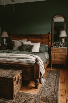 a bedroom with green walls and wooden furniture