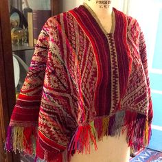 This Is A Beautiful Hand Woven And Super Bright Colors Peruvian Poncho. It Has Fringe All The Way Around. It Is In Very Good Condition. Just One Tiny Snag And A Little Loosening On The Back At The Shoulders. Please See The Last Two Photos. It Is One Size But Measures Shoulder To Shoulder About 16 Inches, And Shoulder To The End Of The Fringe Is About 23 Inches. The Back Hangs Lower Than The Front Of The Poncho. Great Looking Heavy Woven Fabric With Amazing Pinks Reds And Oranges! A Great Additio Traditional Fringed Poncho Shawl, Traditional Fringe Poncho One Size, Handwoven Poncho Shawl For Festivals, Handwoven Festival Poncho Shawl, Bohemian Handwoven Shawl Poncho, Traditional Fringe Poncho For Fall, Traditional Fall Poncho With Fringe, Hippie Fringe Shawl Poncho, Red Bohemian Poncho Cape