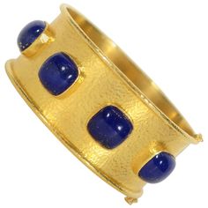 Stunning wide gold bracelet by Elizabeth Locke with four cabochon lapis lazuli stones. The stones are all square in shape. The bracelet is made with Locke's signature hammered gold surface and finished with banded edges. It is no longer in production. The bracelet is 1 1/9 inches tall and 2 1/2 inches outside diameter. It has two safety clasps to keep it secure. Rose Gold Bangle Bracelet, 18k Gold Bangle, Pearl Bangle Bracelet, Elizabeth Locke, Hammered Bangles, Lapis Jewelry, Dragon Bracelet, Lapis Lazuli Jewelry, Rose Gold Bangle